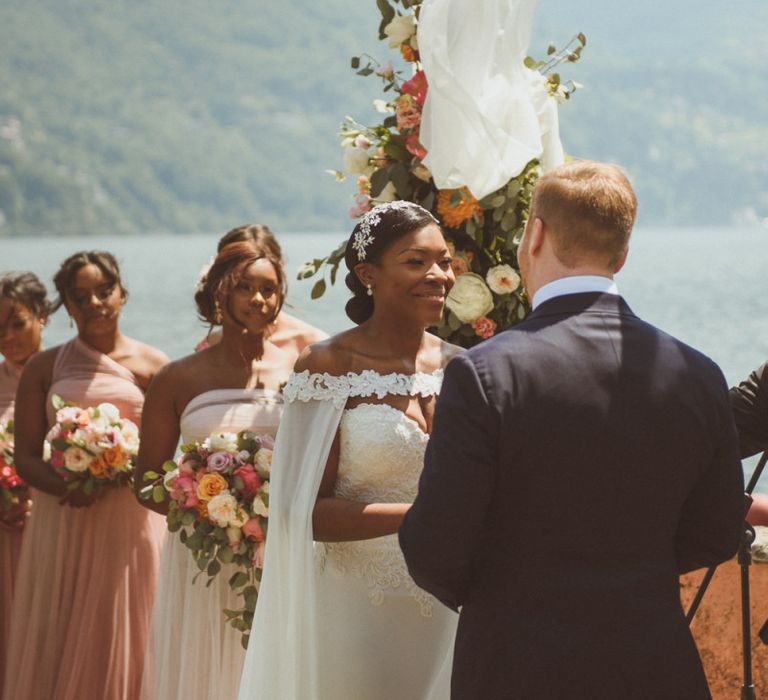 Bride smiling at her groom during wedding ceremony