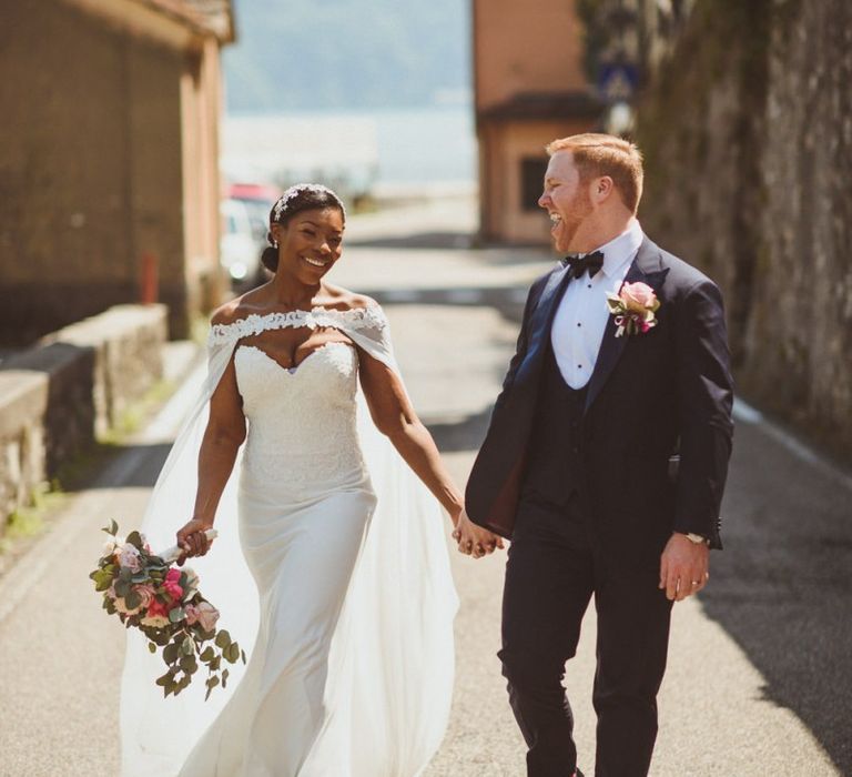 Stylish bride and groom in Tuxedo and bridal cape