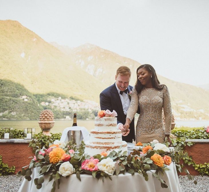 Bride and groom cutting the cake outside at Lake Como wedding