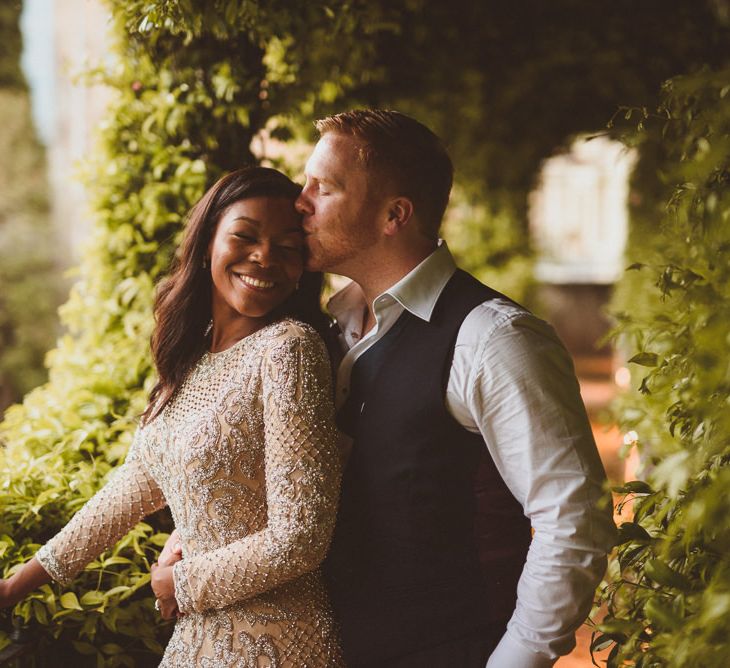 Bride and groom embracing at evening reception