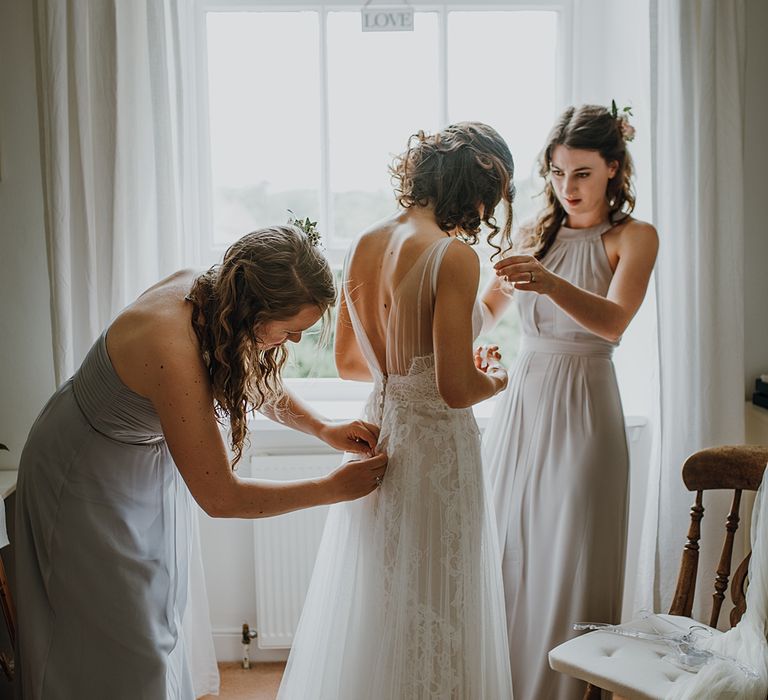 Bridal Morning Preparations. Tipi Wedding at Home, Cumbria. Pale Dusky Pink, White and Mocha Flowers, Handwritten Details and Festoon Lights. Bride wears Essence of Australia Dress from Angelica Bridal. Groom wears Olive Next Suit and Tan Office Shoes.