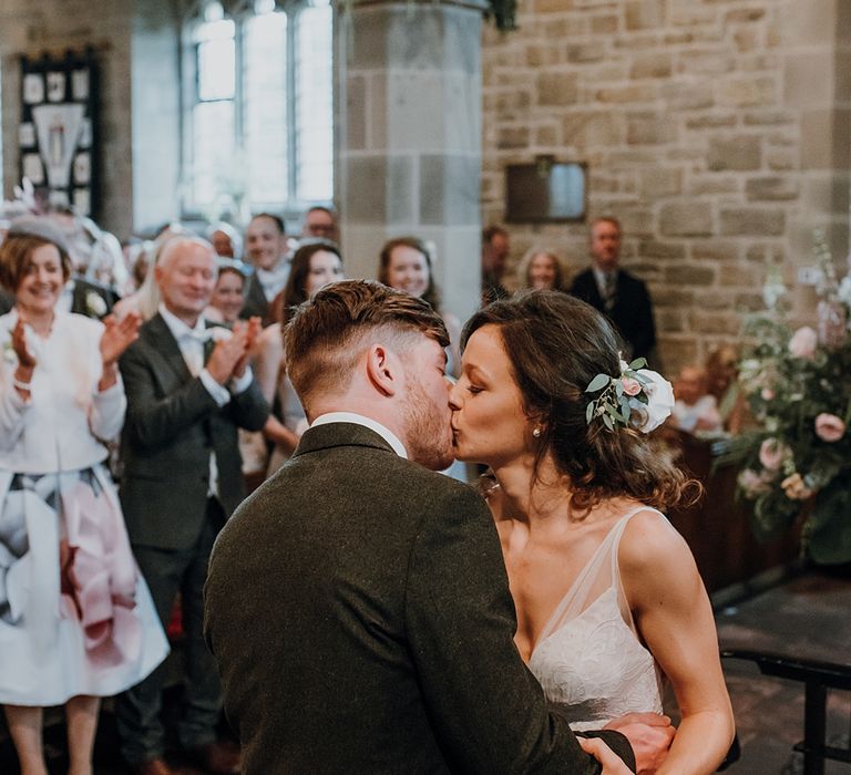 Ceremony. Tipi Wedding at Home, Cumbria. Pale Dusky Pink, White and Mocha Flowers, Handwritten Details and Festoon Lights. Bride wears Essence of Australia Dress from Angelica Bridal. Groom wears Olive Next Suit and Tan Office Shoes.