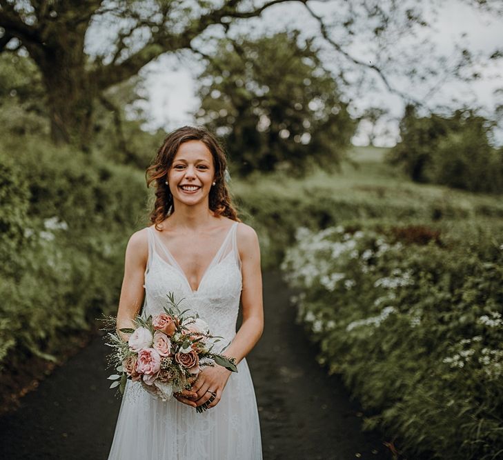 Florals by Mother of the Bride at Abundance Flowers and The Real Flower Company. Tipi Wedding at Home, Cumbria. Pale Dusky Pink, White and Mocha Flowers, Handwritten Details and Festoon Lights. Bride wears Essence of Australia Dress from Angelica Bridal. Groom wears Olive Next Suit and Tan Office Shoes.