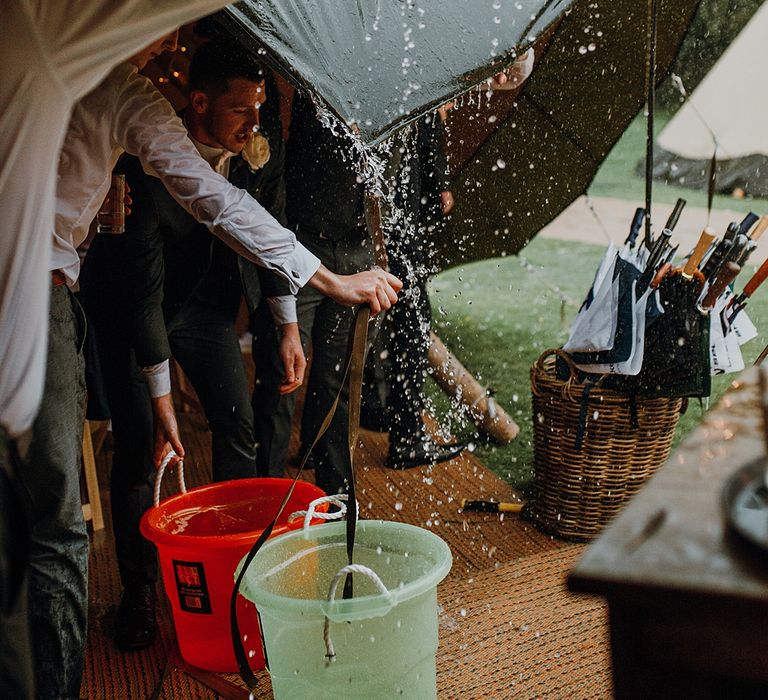 Wet Weather Plan. Tipi Wedding at Home, Cumbria. Pale Dusky Pink, White and Mocha Flowers, Handwritten Details and Festoon Lights. Bride wears Essence of Australia Dress from Angelica Bridal. Groom wears Olive Next Suit and Tan Office Shoes.