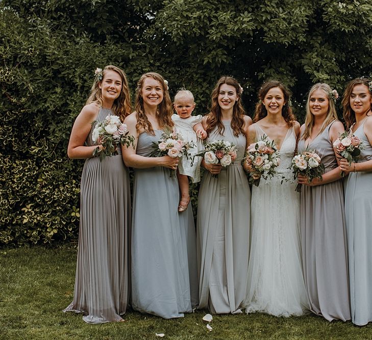 Group Shots. Pale Grey Bridesmaids. Tipi Wedding at Home, Cumbria. Pale Dusky Pink, White and Mocha Flowers, Handwritten Details and Festoon Lights. Bride wears Essence of Australia Dress from Angelica Bridal. Groom wears Olive Next Suit and Tan Office Shoes.