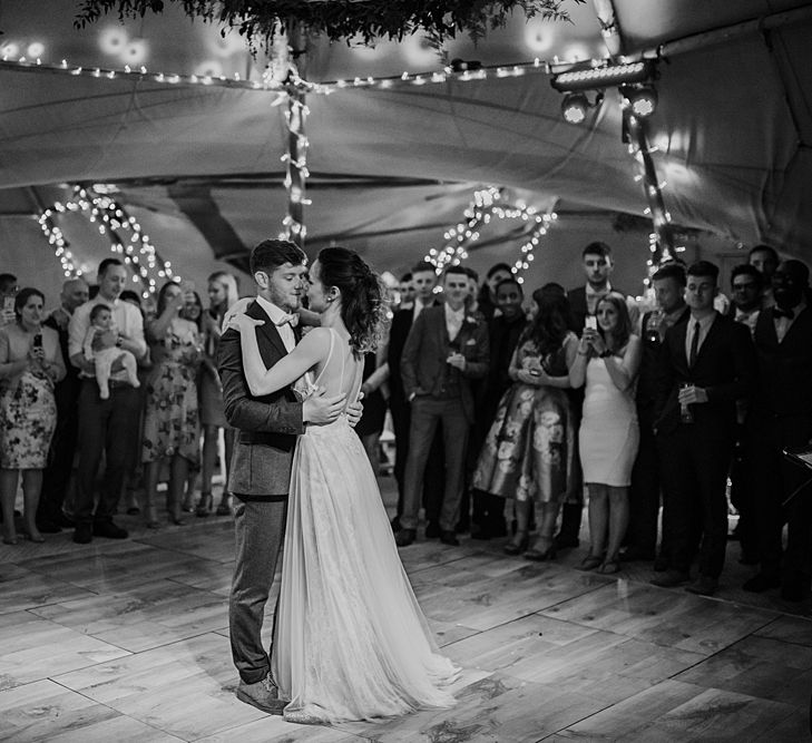 Dancing. Tipi Wedding at Home, Cumbria. Pale Dusky Pink, White and Mocha Flowers, Handwritten Details and Festoon Lights. Bride wears Essence of Australia Dress from Angelica Bridal. Groom wears Olive Next Suit and Tan Office Shoes.