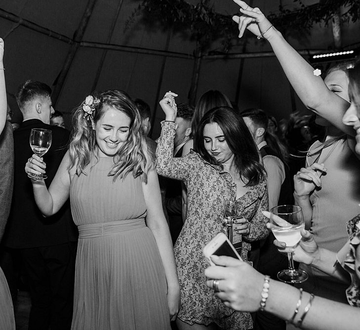 Dancing. Tipi Wedding at Home, Cumbria. Pale Dusky Pink, White and Mocha Flowers, Handwritten Details and Festoon Lights. Bride wears Essence of Australia Dress from Angelica Bridal. Groom wears Olive Next Suit and Tan Office Shoes.