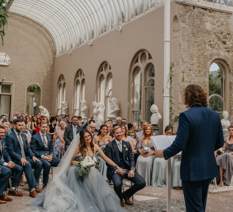 Orangery Wedding Venue at Killruddery House and Gardens in Ireland with Bride  in Tulle Custom Made Blue Claire La Faye Wedding Dress and Groom in Bespoke Alton Lane Suit