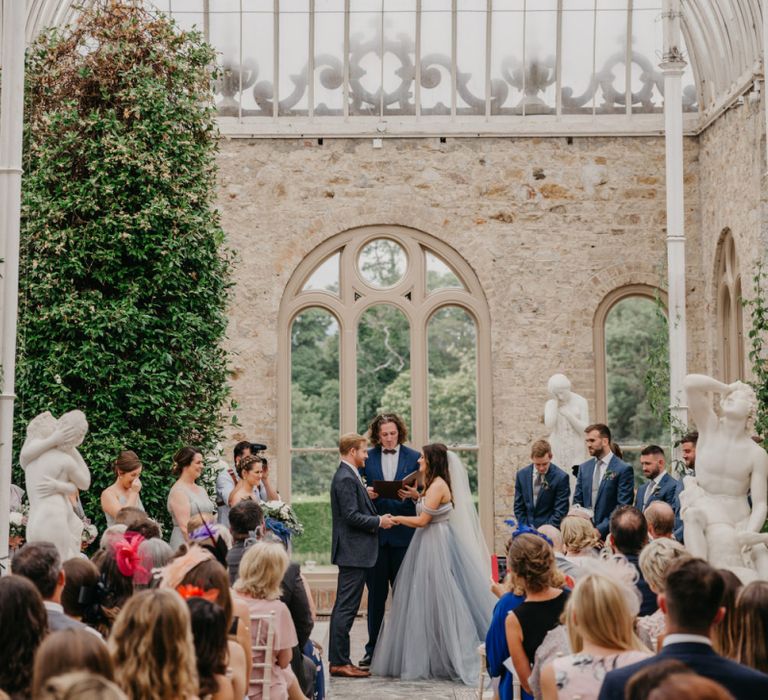 Orangery Wedding Ceremony with Bride  in Tulle Custom Made Blue Claire La Faye Wedding Dress and Groom in Bespoke Alton Lane Suit