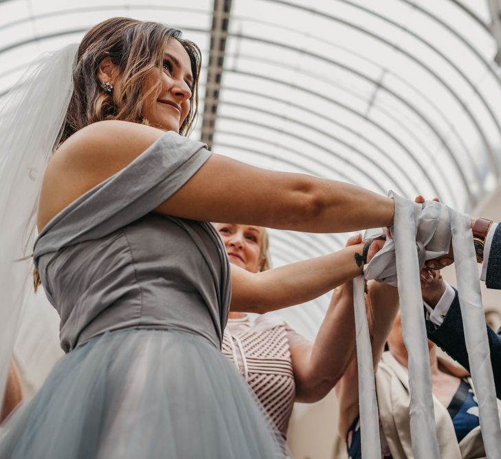 Hand Fastening Wedding Ceremony with Bride  in Tulle Custom Made Blue Claire La Faye Wedding Dress and Groom in Bespoke Alton Lane Suit