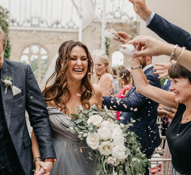 Confetti Wedding Ceremony Exit with Bride  in Tulle Custom Made Blue Claire La Faye Wedding Dress and Groom in Bespoke Alton Lane Suit