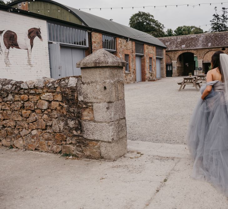 Bride in Custom Made Blue Claire La Faye Wedding Dress Walking to the Venue