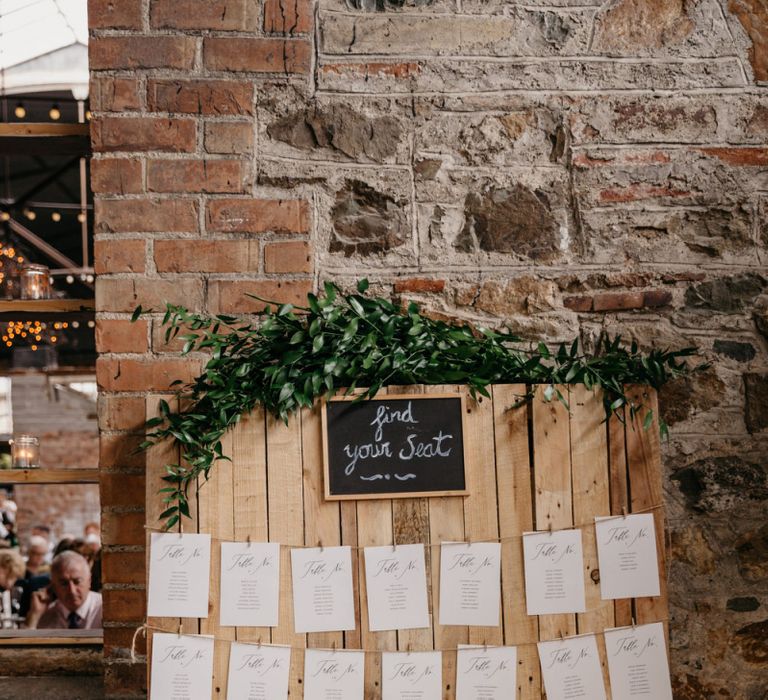 Wooden Table Plan with Strung Up Tables and Greenery Garland