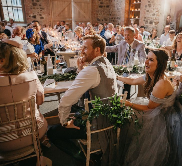 Bride and Groom Enjoying the Wedding Reception Speeches