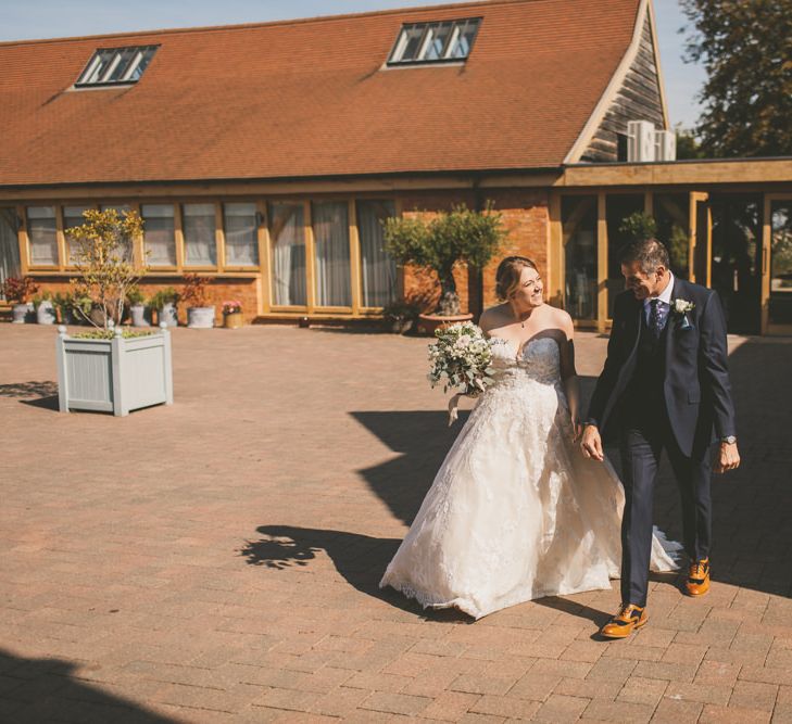 Bride makes her way to ceremony at Bassmead Manor Barns wedding venue