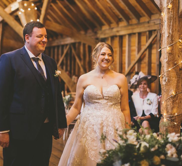 Bride and groom exchange their vows at rustic barn ceremony