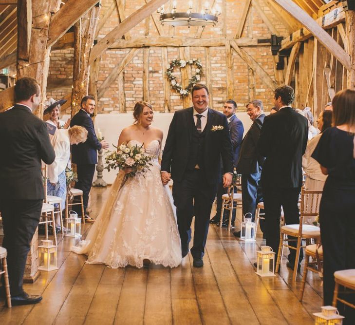 Bride and groom exchange their vows at rustic barn ceremony