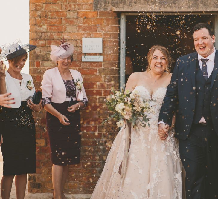 Confetti exit for bride and groom at Bassmead Manor Barns  wedding