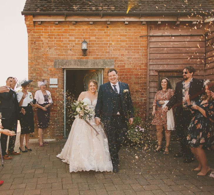 Confetti exit for bride and groom at Bassmead Manor Barns  wedding