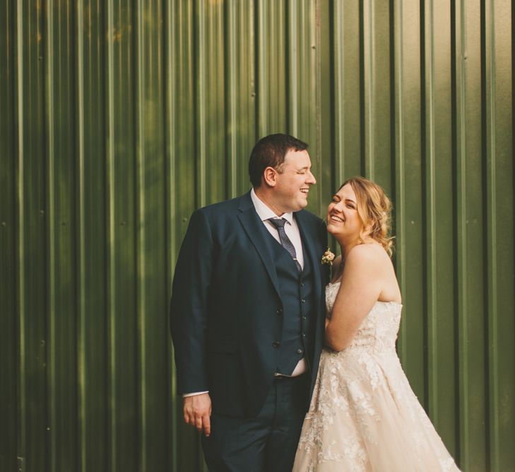 Relaxed summer wedding with groom in navy suit