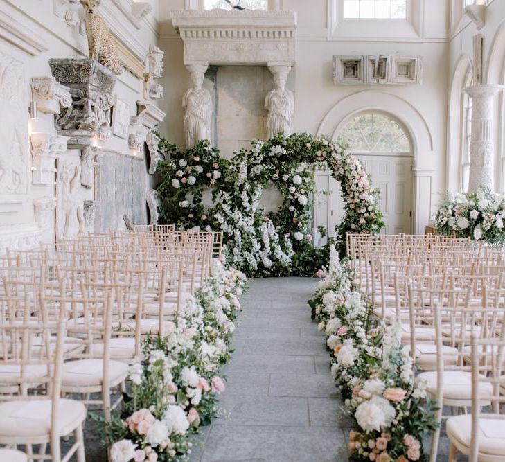 Aisle and altar wedding flowers at Aynhoe Park Orangery