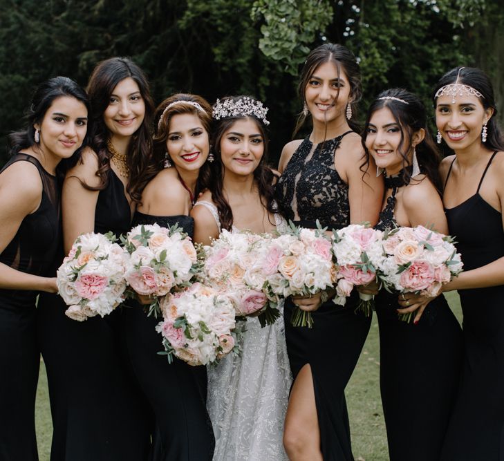 Bridal party portrait with bridesmaids in black dresses and bride in Berta Bridal gown