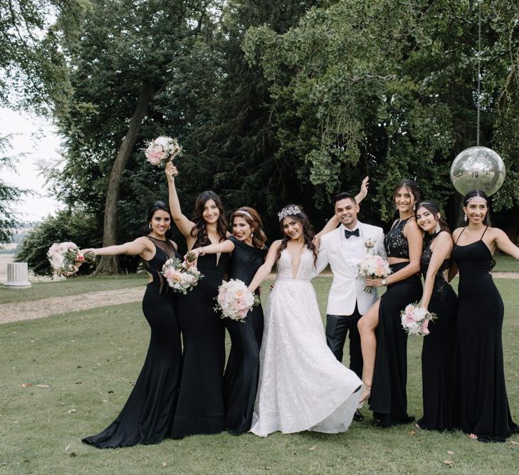 Bride and groom with bridesmaids at black-tie wedding with Berta Bridal gown