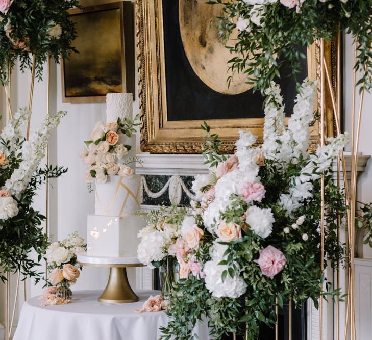 Dessert table with luxury wedding cake and floral decor