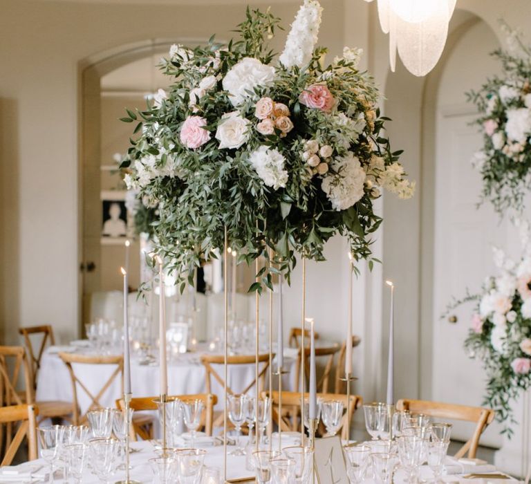 Blush pink and white floral centrepiece on high gold stand