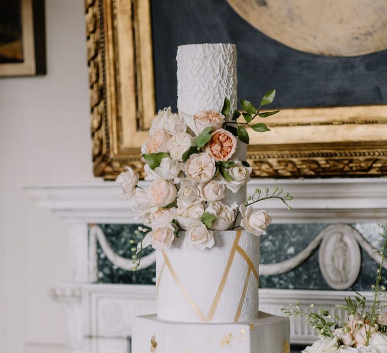 Luxury wedding cake with gold detail and blush wedding flowers