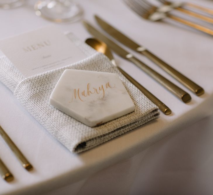 Marble name place setting with gold font for luxury wedding at Aynhoe Park with Berta Bridal gown