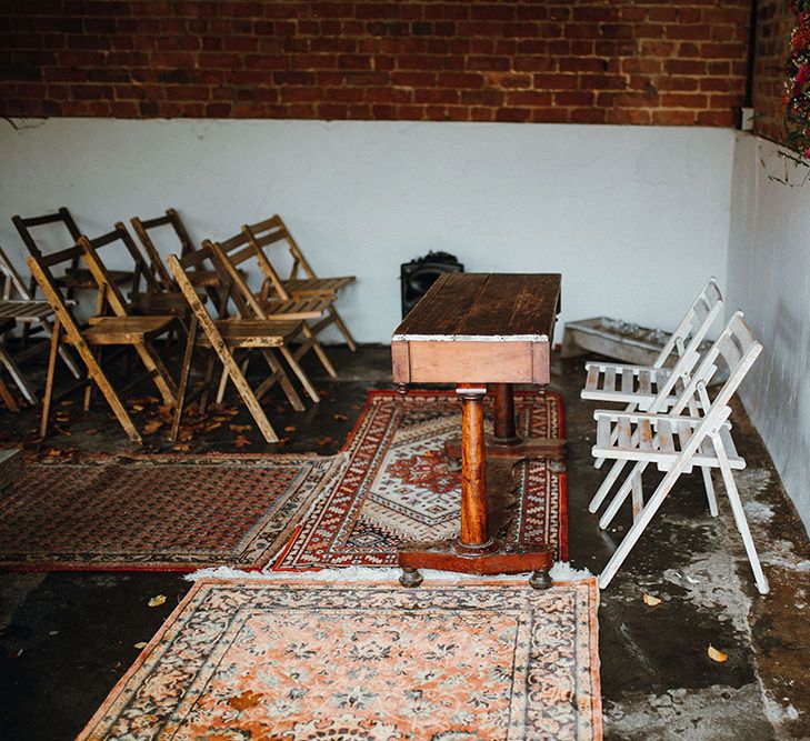 Persian Rugs and Autumn Leaves Lining Aisle | Floral Wreath Altar | Rustic Bureau | Mariachi Band and Persian Rug Aisle for Autumn Wedding | Leah Lombardi Weddings