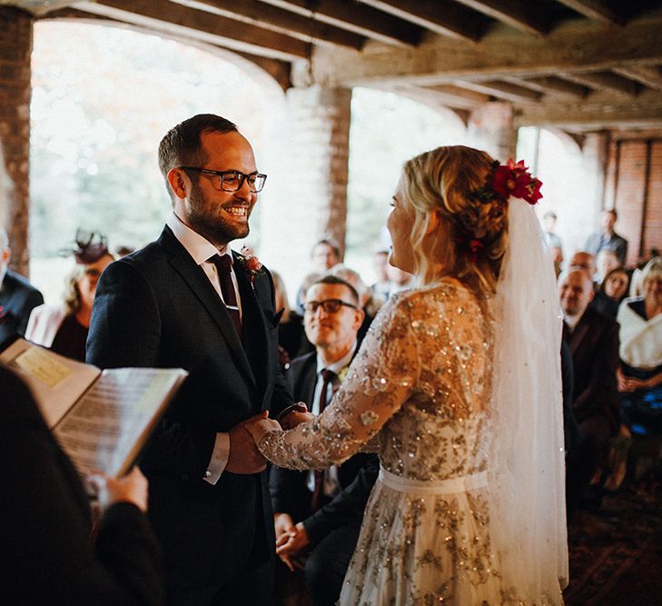 Bride in Bead Embellished Needle &amp; Thread Gown with Cascading Tulle Skirt and Semi-Sheer Sleeves | Elbow Length Veil | Bridal Up Do with Pink Hair Flowers | Groom in Check Blue Three-Piece Suit by T.M.Lewin with Maroon Tie and Pocket Square | Wedding Ceremony at Pimhill Barn | Mariachi Band and Persian Rug Aisle for Autumn Wedding | Leah Lombardi Weddings