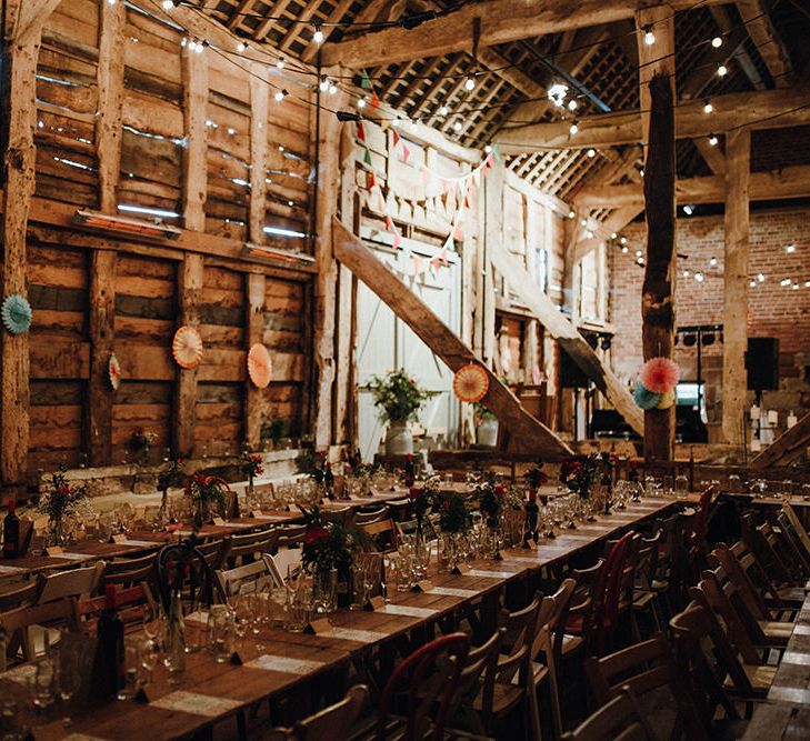 Wooden Banquet Tables | Mismatched Rustic Chairs | Paper Fans | Festoon Lights | Bunting | Kraft Place Settings | Pink, Orange and Maroon Flowers for Tables | Mariachi Band and Persian Rug Aisle for Autumn Wedding | Leah Lombardi Weddings