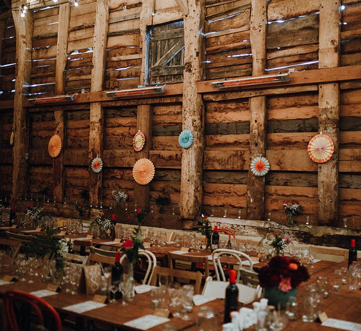 Wooden Banquet Tables | Mismatched Rustic Chairs | Paper Fans | Kraft Place Settings | Pink, Orange and Maroon Flowers for Tables | Mariachi Band and Persian Rug Aisle for Autumn Wedding | Leah Lombardi Weddings