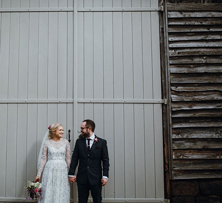 Bride in Bead Embellished Needle &amp; Thread Gown with Cascading Tulle Skirt and Semi-Sheer Sleeves | Elbow Length Veil | Bridal Up Do with Pink Hair Flowers | Groom in Check Blue Three-Piece Suit by T.M.Lewin with Maroon Tie and Pocket Square | Purple, Orange and Pink Flowers with Foliage and Maroon Trailing Ribbon | Mariachi Band and Persian Rug Aisle for Autumn Wedding | Leah Lombardi Weddings