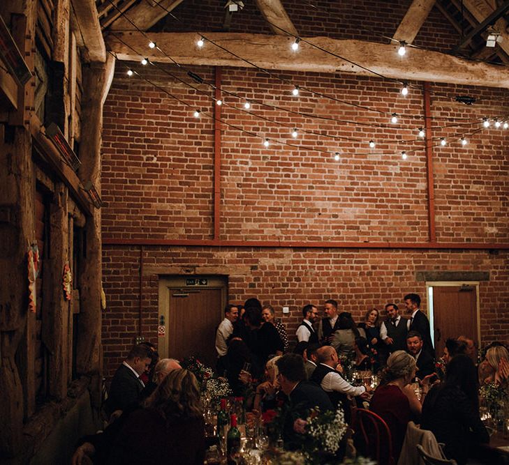 Festoon Lights | Paper Fans | Wooden Banqueting Tables | Wedding Reception at Pimhill Barn | Mariachi Band and Persian Rug Aisle for Autumn Wedding | Leah Lombardi Weddings