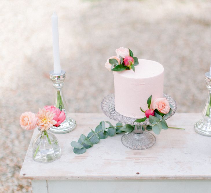 Delicate Pink Single Tier Wedding Cake on Glass Stand with Candlesticks and Fresh Flower Table Decor