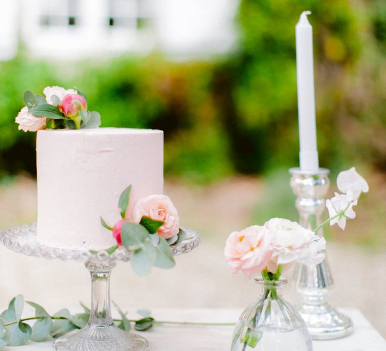 Delicate Pink Single Tier Wedding Cake on Glass Stand with Candlesticks and Fresh Flower Table Decor