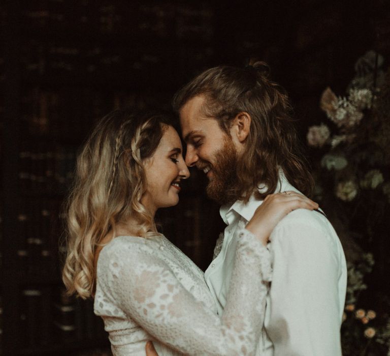 Bride in Separates and Groom in Chinos and Braces Looking into Each Others Eyes