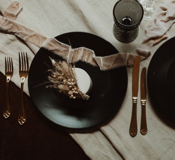 Black Tableware with Gold Cutlery and Linen Table Runner