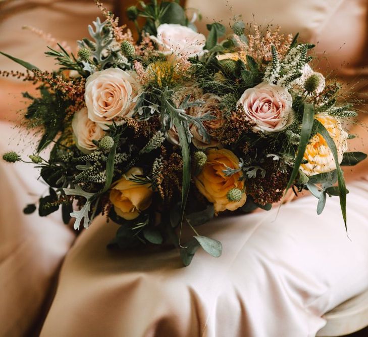 Peach and neutral floral bridesmaids bouquets at Wales wedding venue