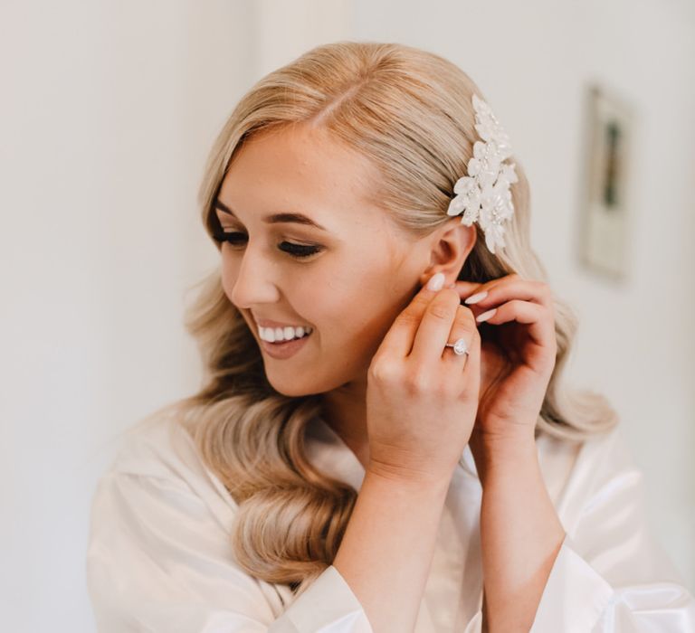 Bride getting ready for reception at Wales wedding venue wearing hair accessory