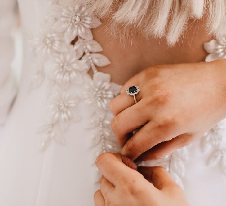 Back of brides dress with floral embellishment at autumn wedding in Wales