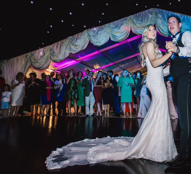 Bride in strapless evening dress with lace tipped details for first dance at Wales wedding venue