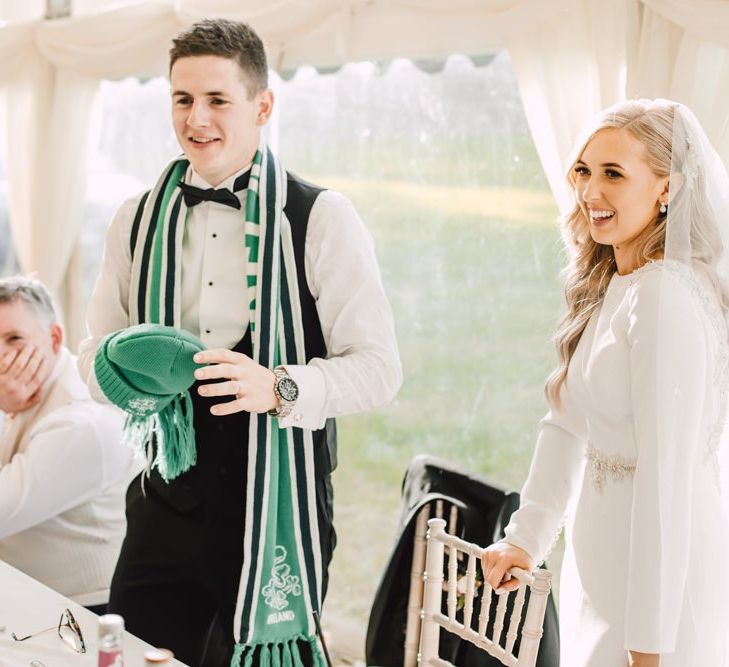 Bride and groom celebrate at their Wales wedding venue and marquee reception