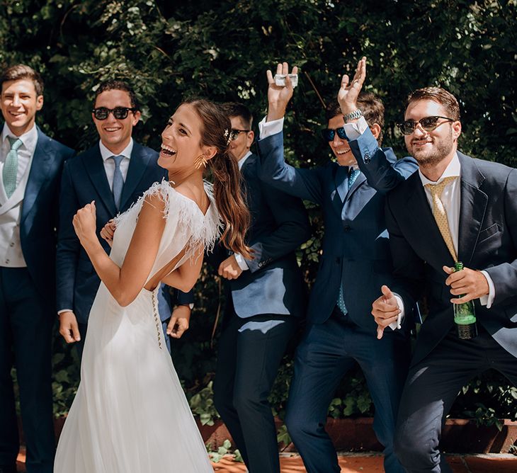 Bride in Sole Alonso Feather Trim Wedding Dress | Groomsmen in Navy Suits | Malaga Destination Wedding | Sara Lobla Photography | Un Par de Medias Film