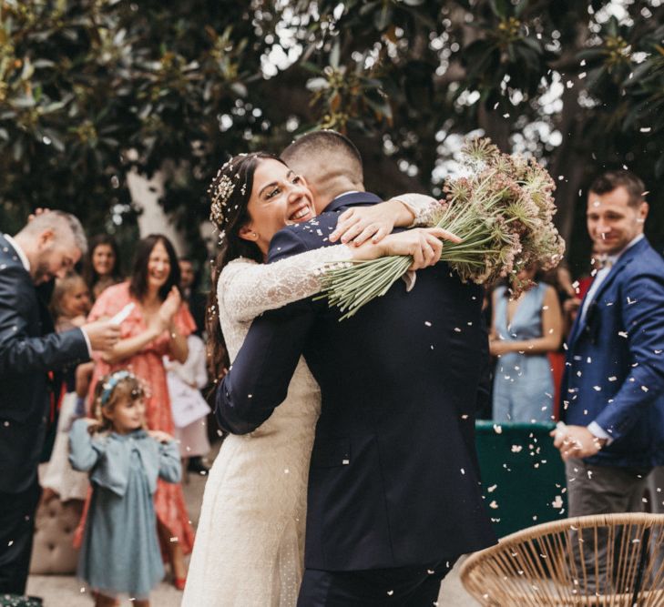 Bride in Otaduy dress embraces groom