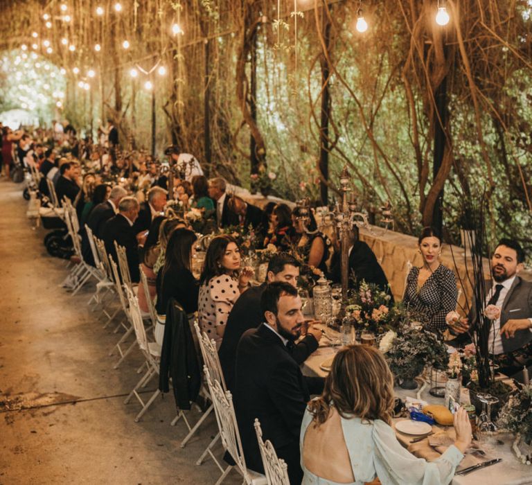 Flower tunnel with hanging lights for wedding breakfast