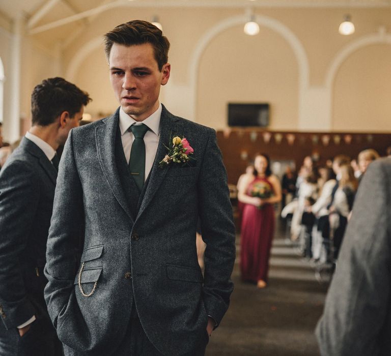 Groom in wool suit waiting at the altar